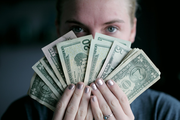 Woman fanning currency like playing cards